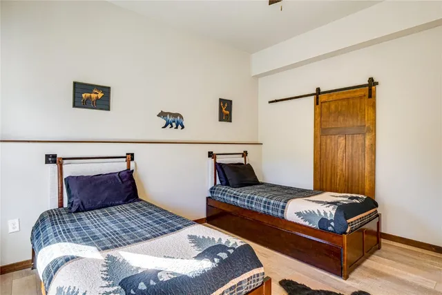 a bedroom with a bed and a painting on the wall