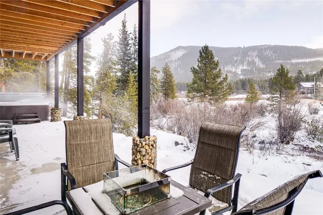 a view of a white building among the street with palm trees