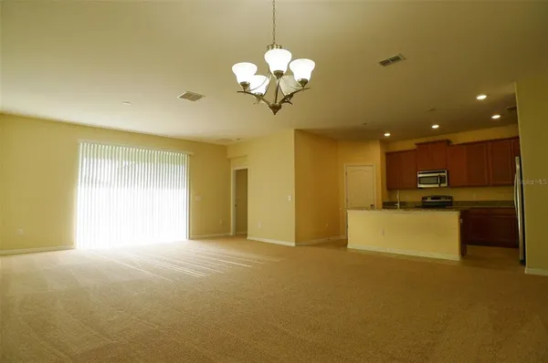 a view of a kitchen with a sink and a chandelier