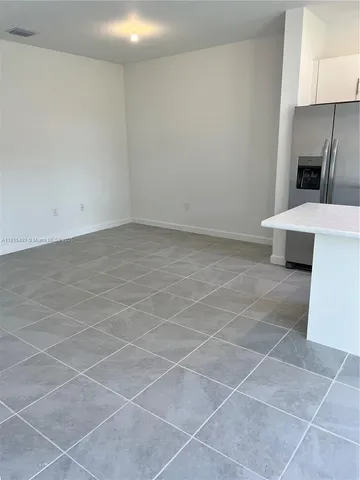 a kitchen with stainless steel appliances granite countertop a refrigerator and a stove