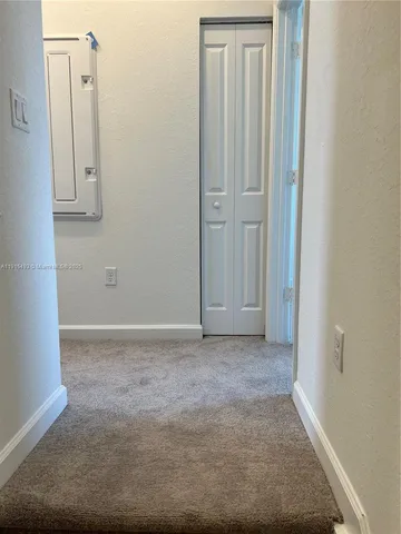 an empty room with closet area