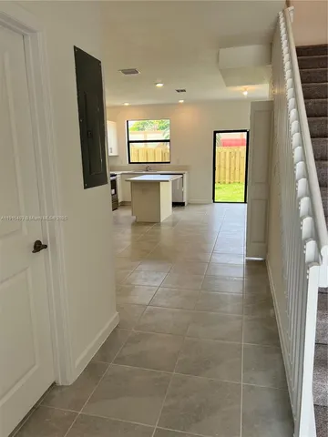 a view of kitchen with stainless steel appliances granite countertop a sink and a stove top oven