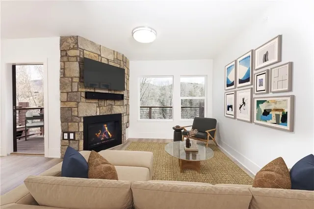 a living room with furniture fireplace and flat screen tv