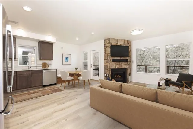 a living room with furniture wooden floor and a fireplace