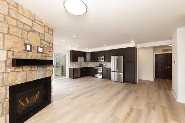 a large kitchen with a stove and a refrigerator