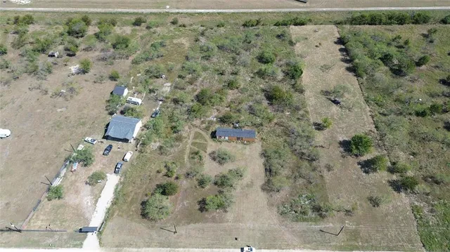an aerial view of a houses with a yard