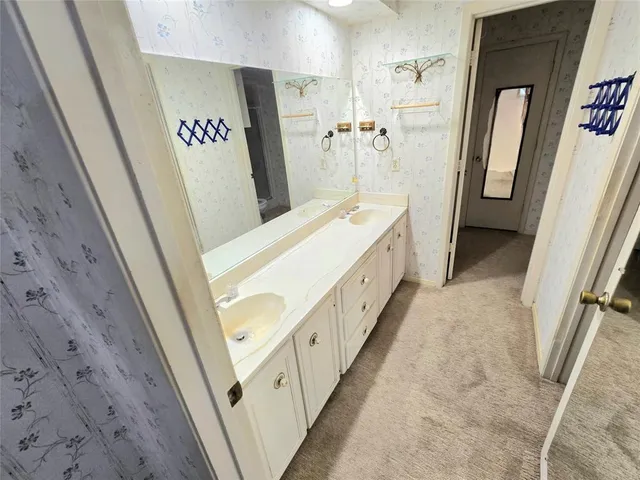 a bathroom with a double vanity sink and a shower