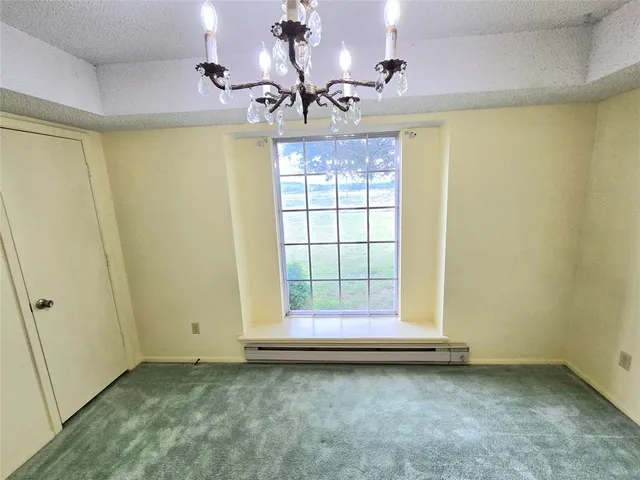 a view of wooden door and chandelier in a room