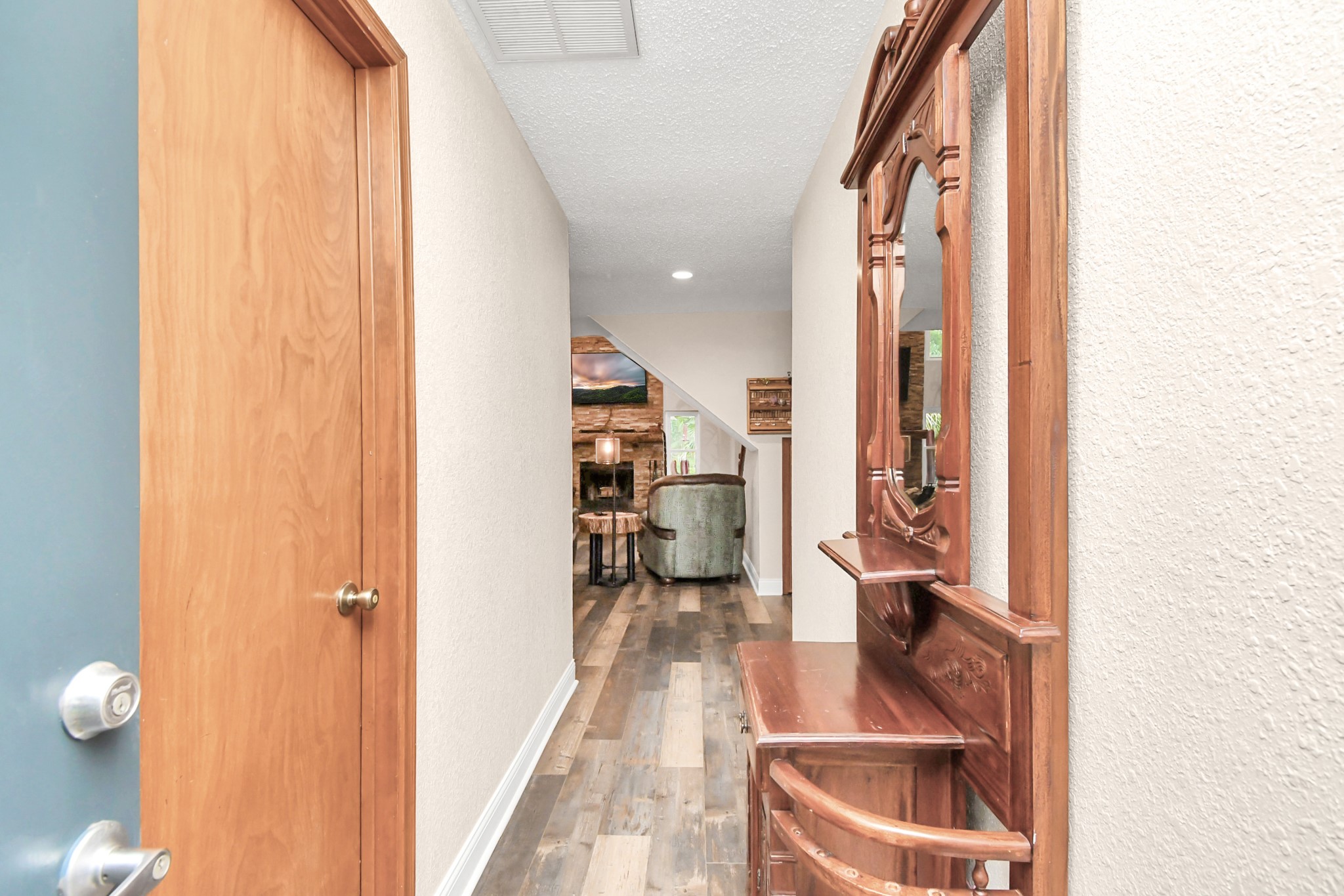 20202 Deer Run Road Damon, TX 77430 - Photo 9 of 45 a view of a hallway with wooden floor and a bathroom
