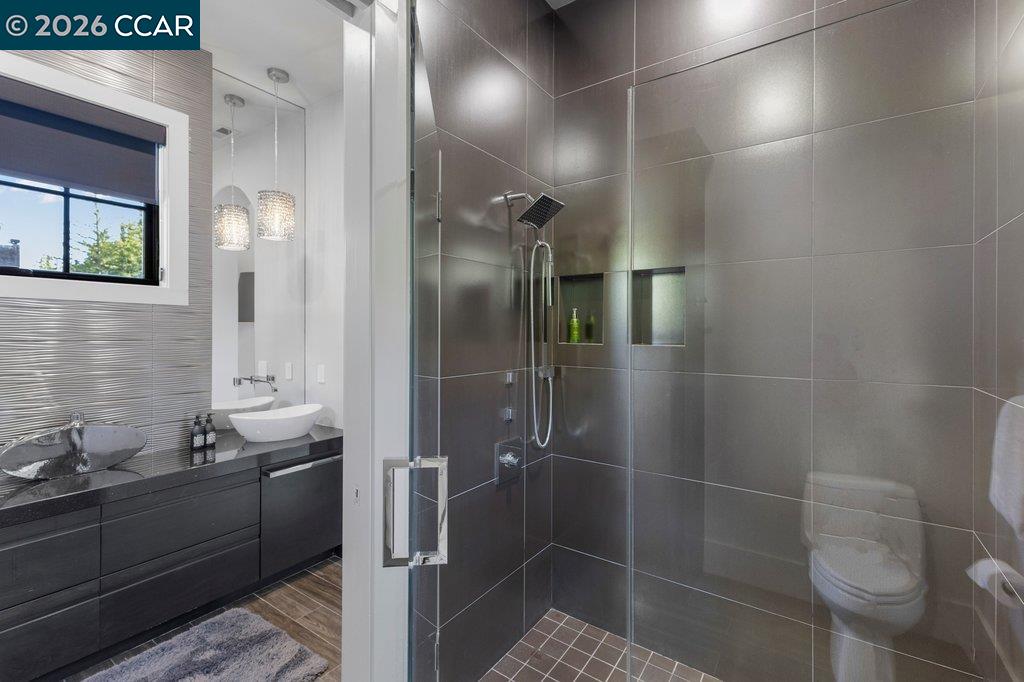 640 El Pintado Road Danville, CA 94526 - Photo 51 of 60 a bathroom with a granite countertop sink a toilet and shower