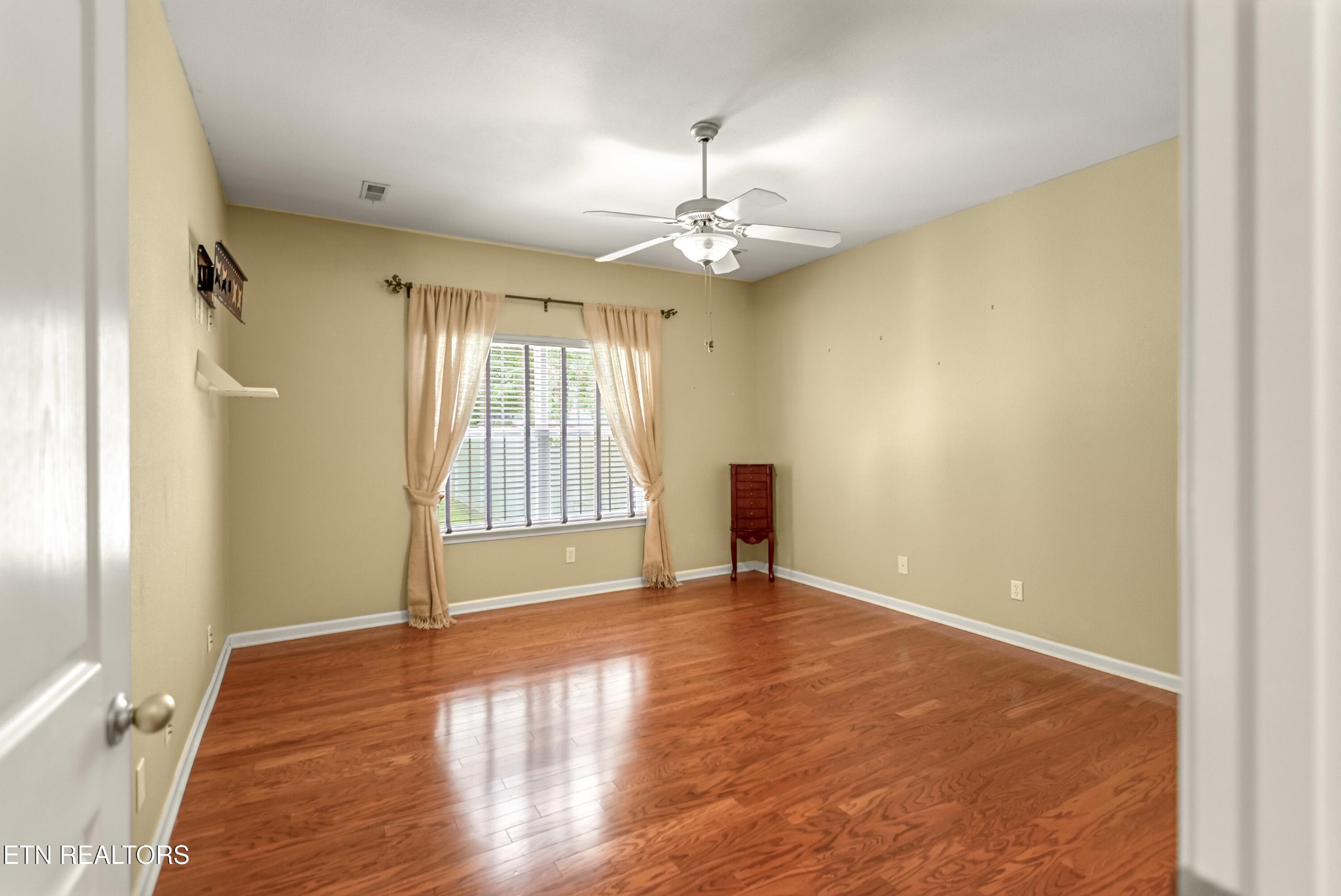 7204 Oakfield Lane Powell, TN 37849 - Photo 15 of 43 an empty room with wooden floor and windows