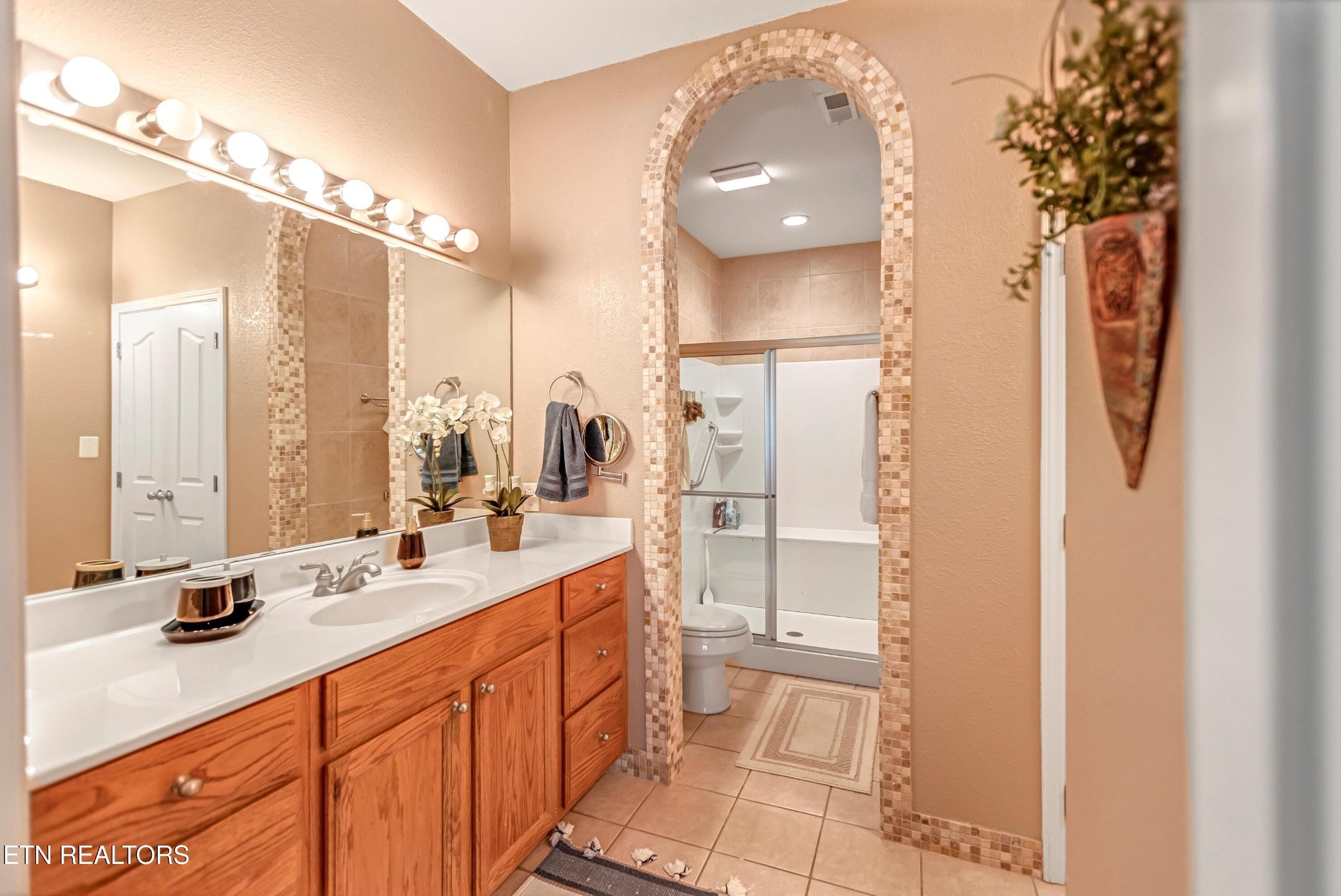 7204 Oakfield Lane Powell, TN 37849 - Photo 17 of 43 a bathroom with a double vanity sink a mirror and a shower