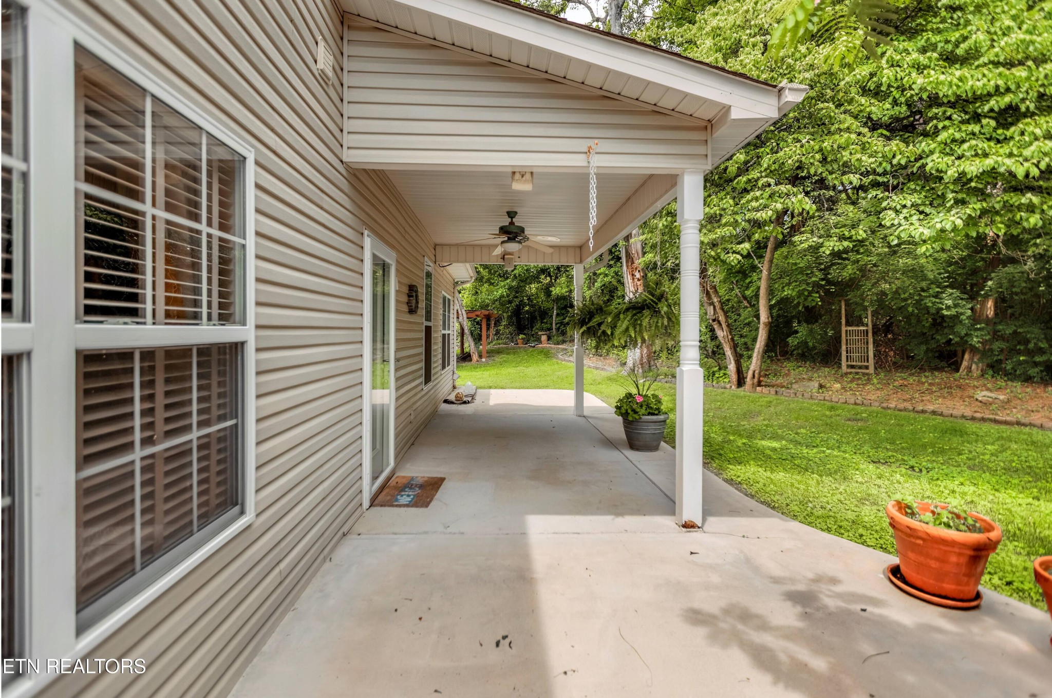 7204 Oakfield Lane Powell, TN 37849 - Photo 37 of 43 a view of a house with a backyard and a patio