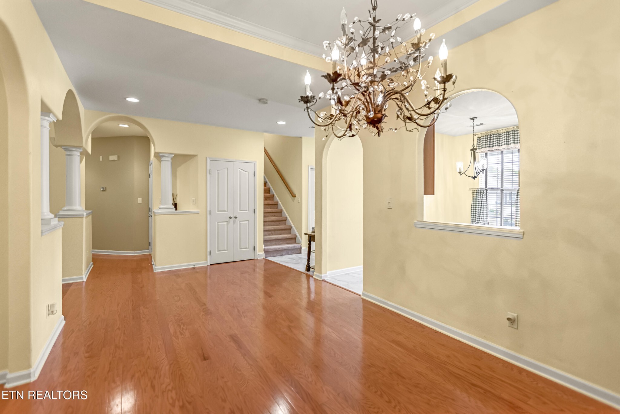 7204 Oakfield Lane Powell, TN 37849 - Photo 7 of 43 a view of a hallway with wooden floor and chandelier