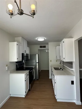 a kitchen with stainless steel appliances kitchen island granite countertop a sink and a stove