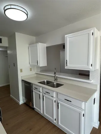 a kitchen with stainless steel appliances granite countertop a sink and a stove