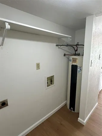 a view of a storage & utility room with a mirror