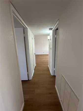 a view of gallery with wooden floor