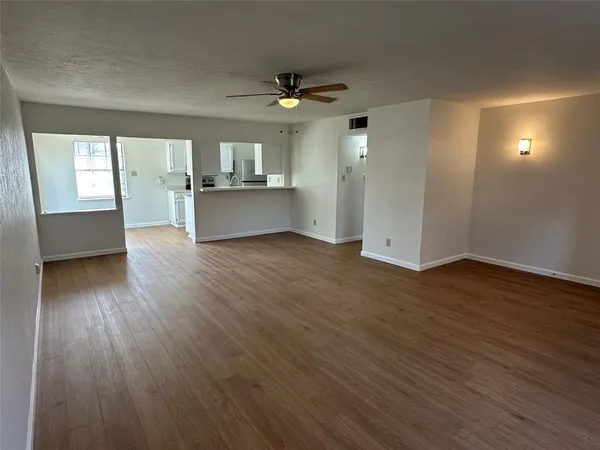 a view of a kitchen with wooden floor and a kitchen