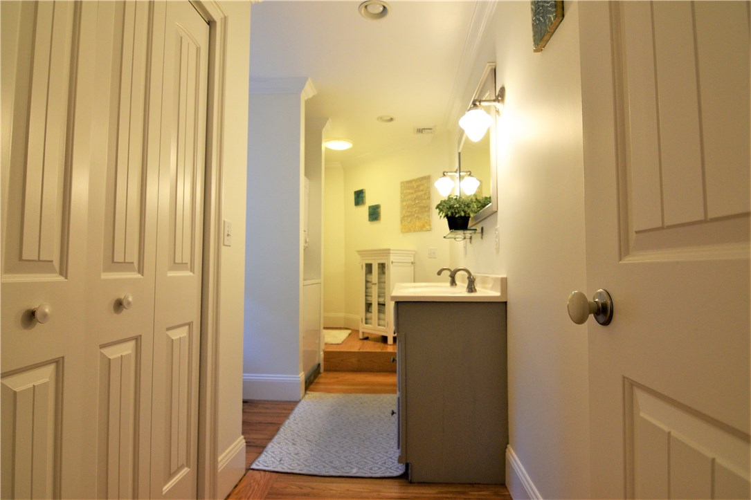 26 Phelps Road Middletown, RI 02842 - Photo 12 of 27 The principal bathroom has a walk-in closet, double vanity, shower tub and stackable washer/dryer.