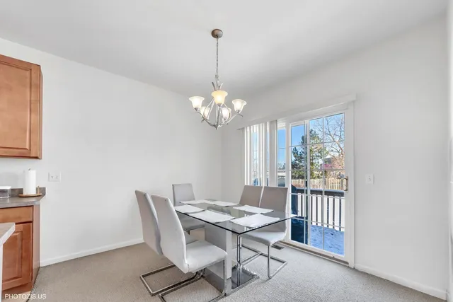 a dining room with furniture a rug and a chandelier