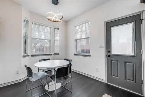 a dining room with wooden floor and a window