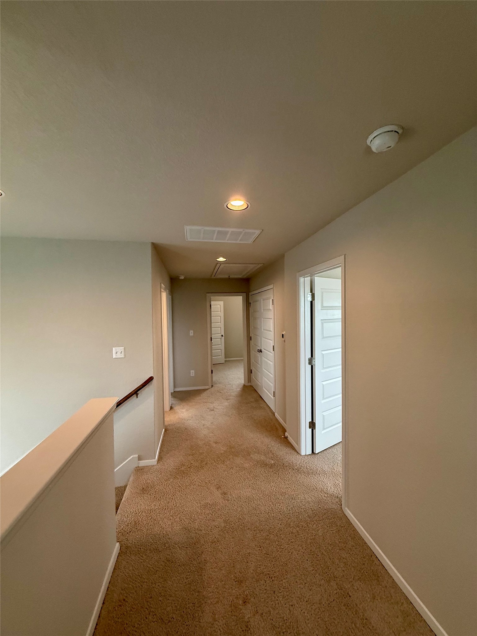 212 Lake Placid Run Elgin, TX 78621 - Photo 11 of 27 Carpeted hallways lead to a series of well-defined rooms, offering privacy and flow.