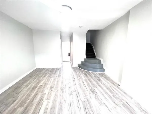 a view of a room with wooden floor and stairs