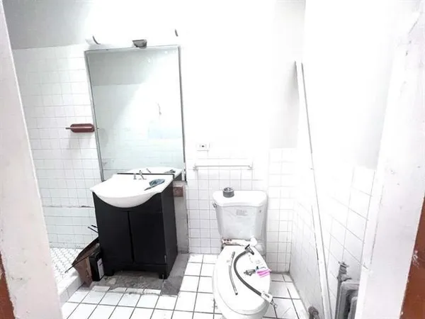 a bathroom with a sink toilet and mirror