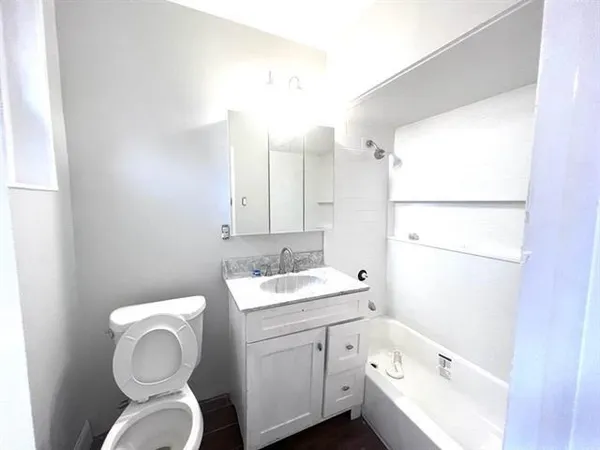 a bathroom with a sink a toilet and a mirror