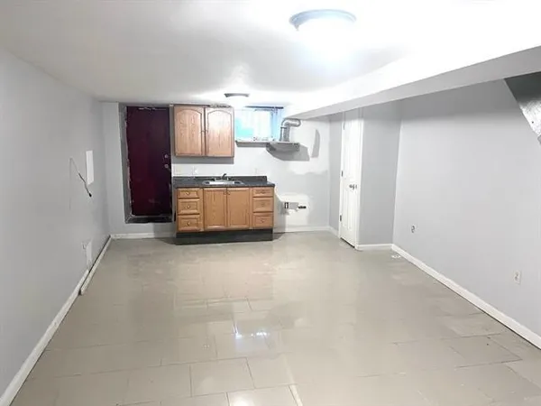 a large white kitchen with a sink