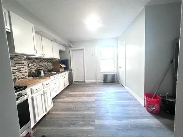 a view of an empty room and wooden floor