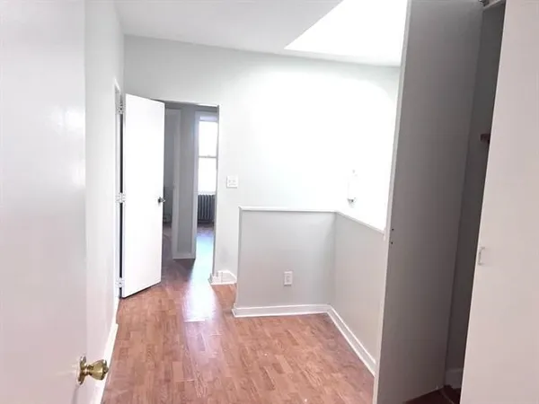 a view of hallway with wooden floor