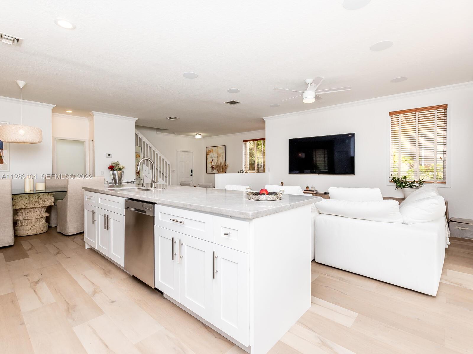 471 Fishtail Terrace Weston, FL 33327 - Photo 16 of 64 a large white open kitchen with a sink and white cabinets