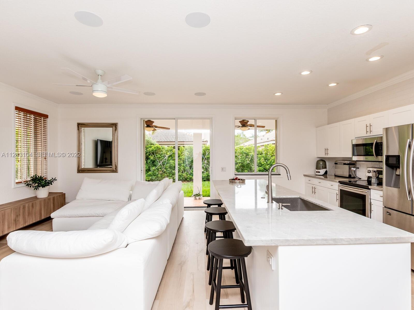 471 Fishtail Terrace Weston, FL 33327 - Photo 25 of 64 a living room with furniture a large window and a dining table