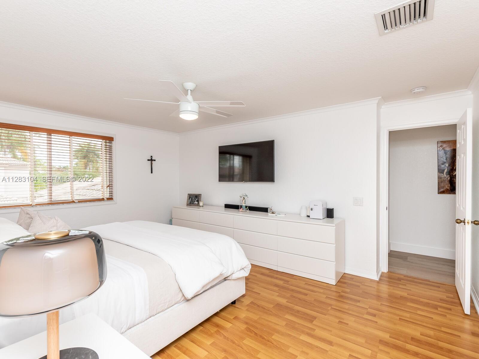 471 Fishtail Terrace Weston, FL 33327 - Photo 32 of 64 a spacious bedroom with a bed and a flat screen tv