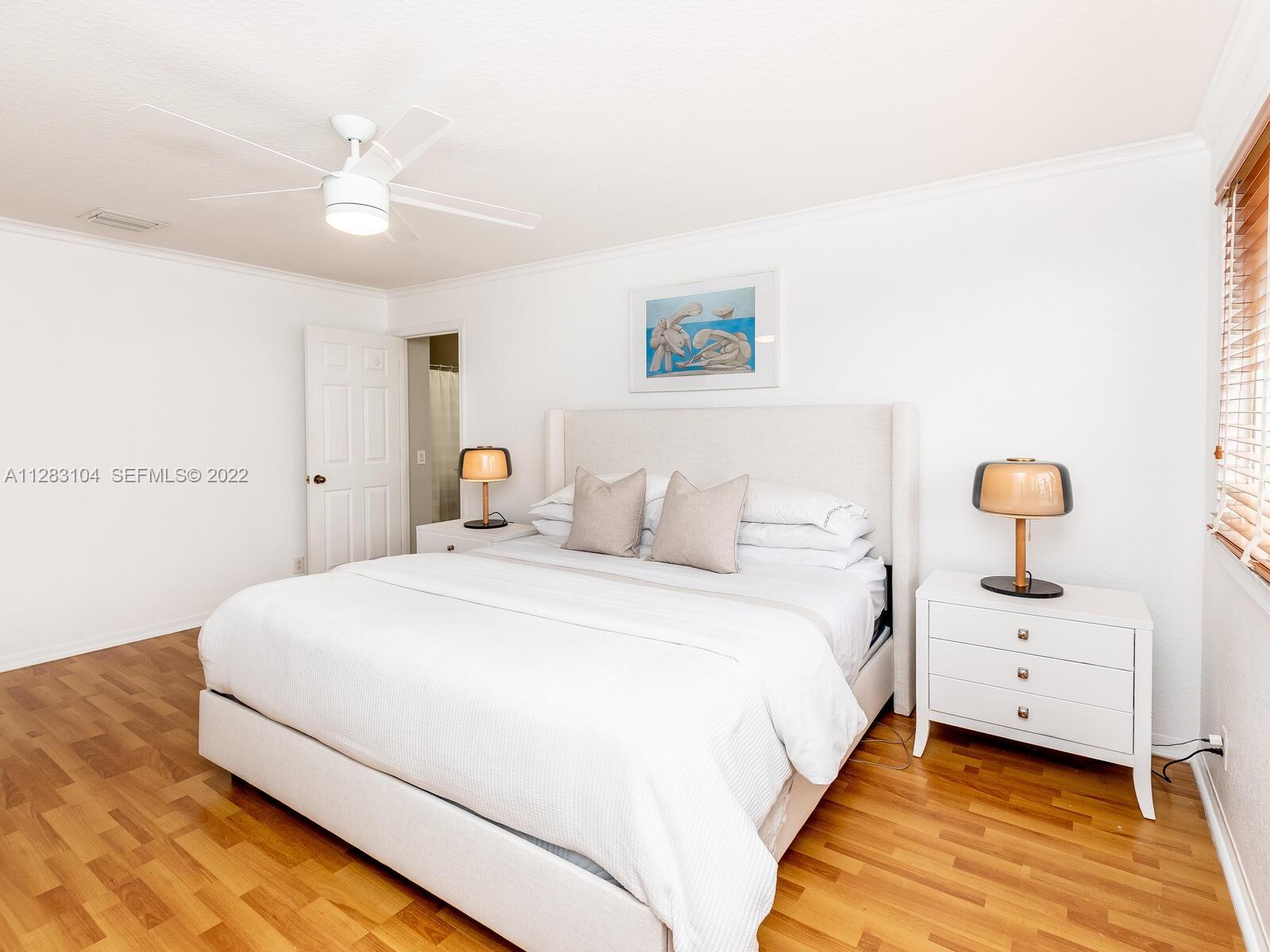 471 Fishtail Terrace Weston, FL 33327 - Photo 34 of 64 a spacious bedroom with a bed and a lamp