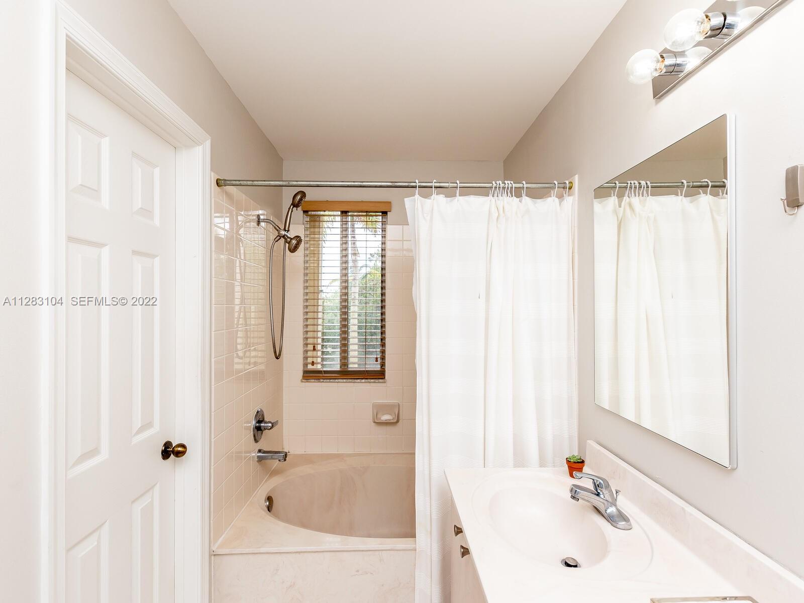 471 Fishtail Terrace Weston, FL 33327 - Photo 36 of 64 a bathroom with a tub a sink and a window