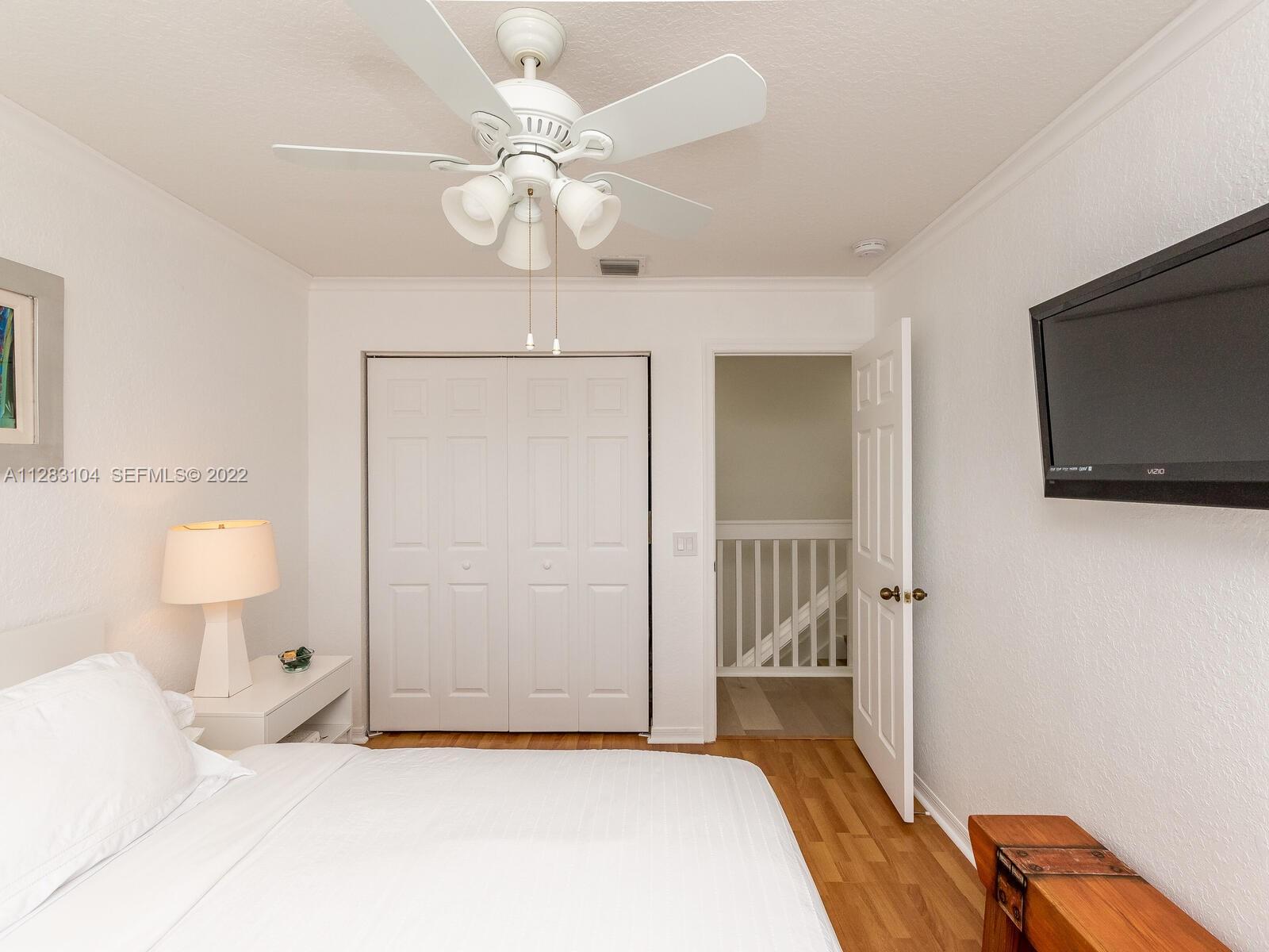 471 Fishtail Terrace Weston, FL 33327 - Photo 38 of 64 a bedroom with a bed and a flat tv screen on dresser