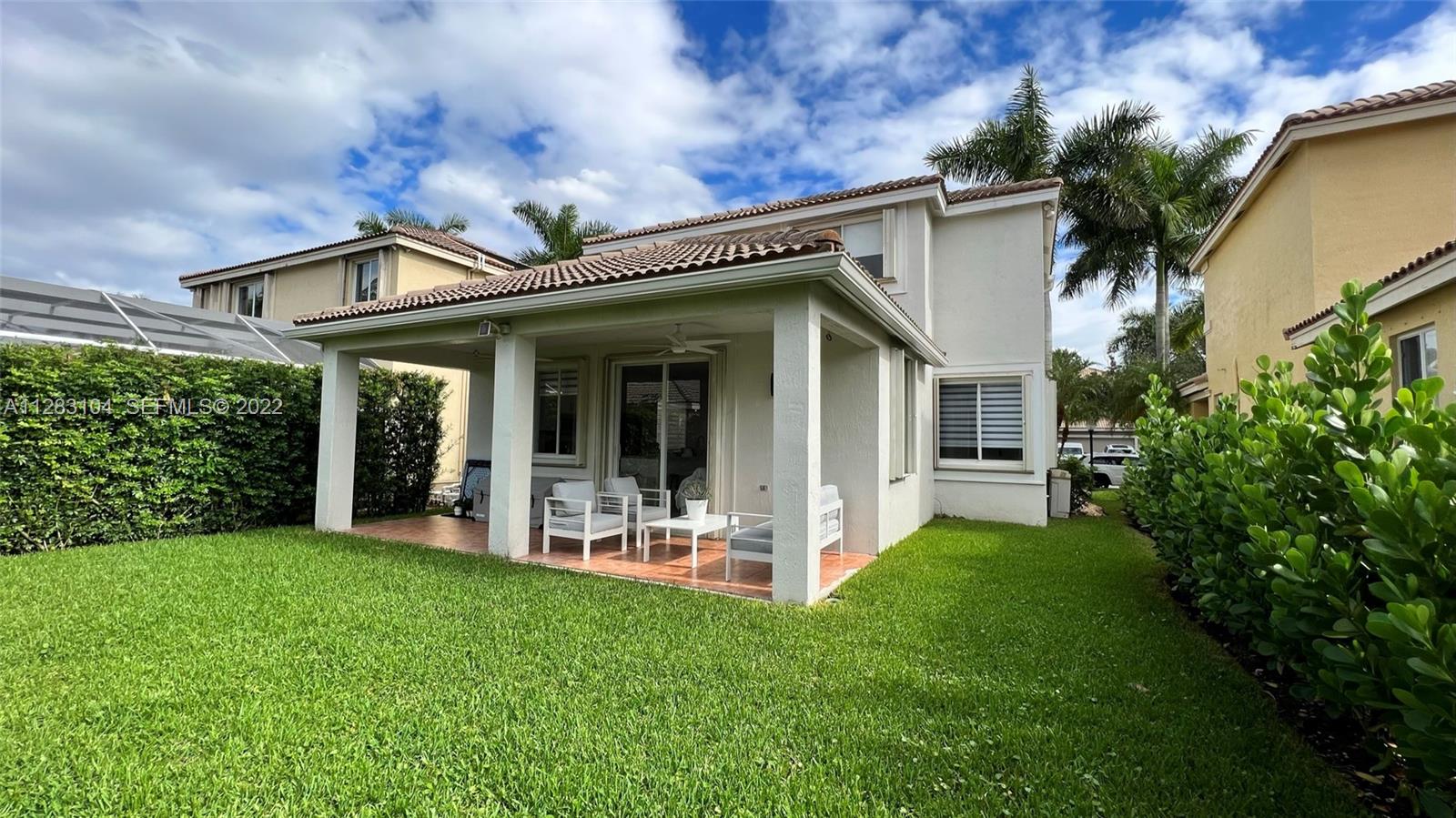 471 Fishtail Terrace Weston, FL 33327 - Photo 46 of 64 a view of a house with a yard and porch