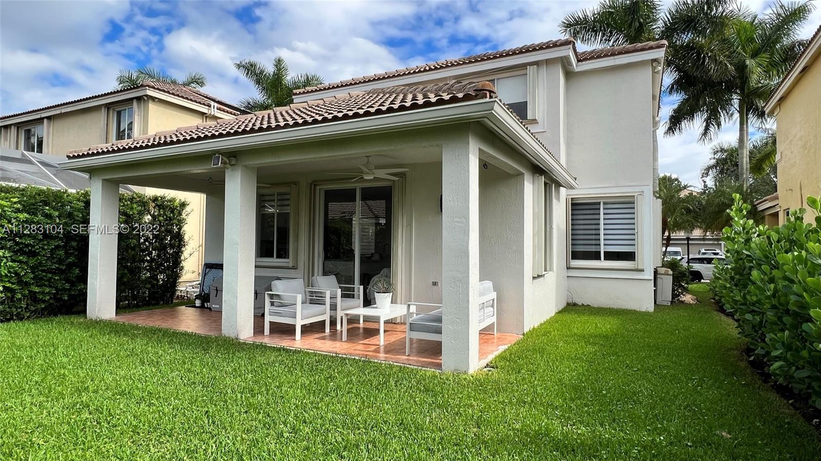 471 Fishtail Terrace Weston, FL 33327 - Photo 47 of 64 a front view of a house with a garden and plants