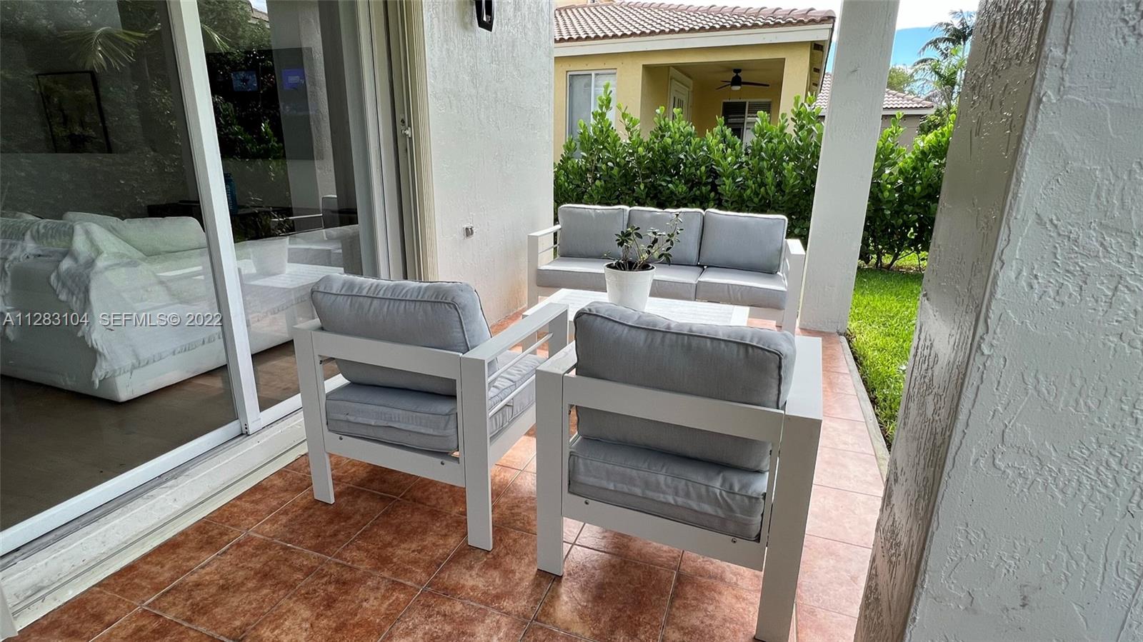 471 Fishtail Terrace Weston, FL 33327 - Photo 49 of 64 a outdoor living space with furniture and a potted plant