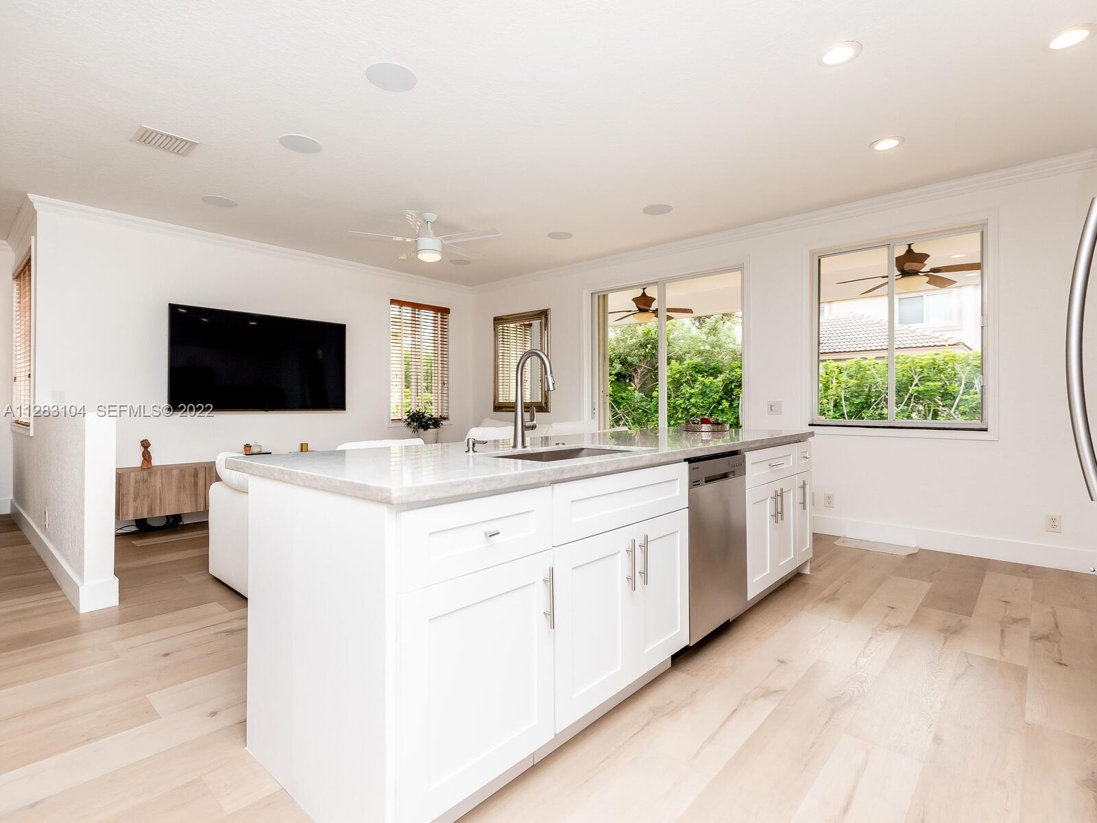 471 Fishtail Terrace Weston, FL 33327 - Photo 5 of 64 a large white kitchen with sink and white cabinets