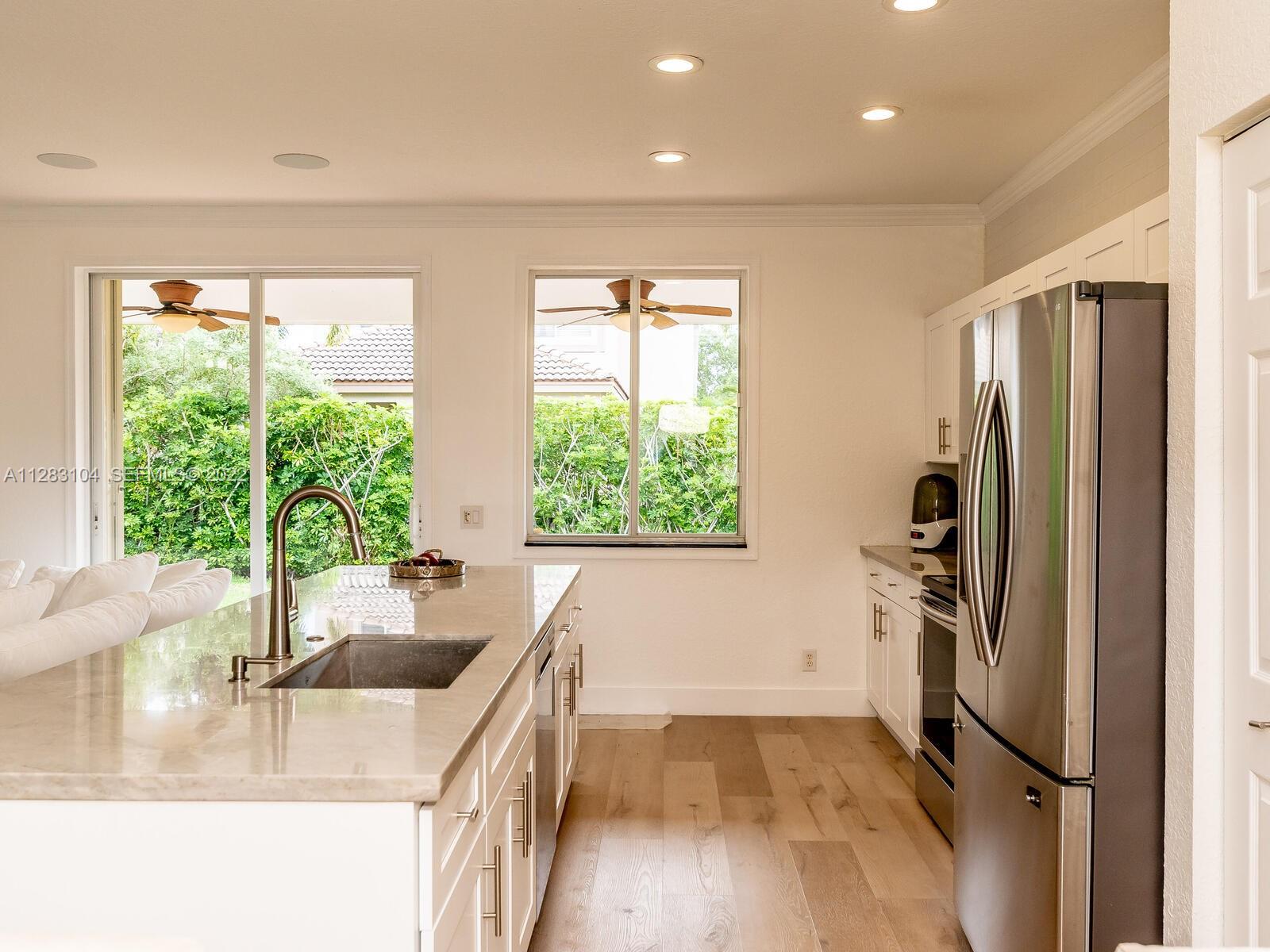 471 Fishtail Terrace Weston, FL 33327 - Photo 7 of 64 a kitchen with stainless steel appliances granite countertop a sink a refrigerator and a granite counter tops with a large window