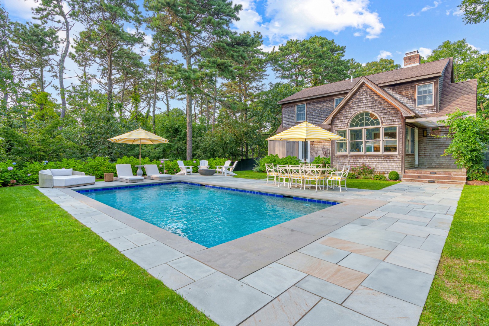 a view of a house with a yard and sitting area