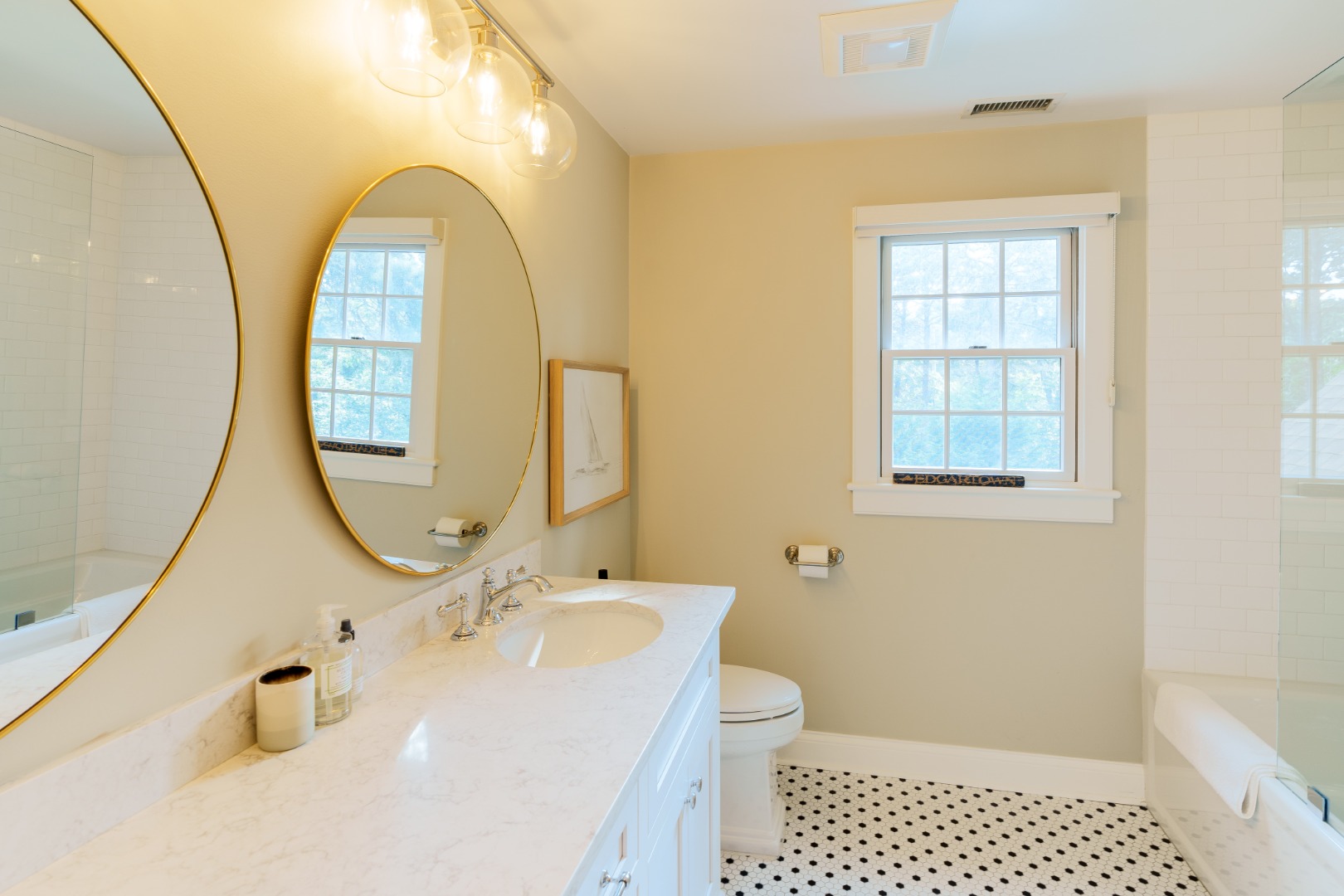 70 Marthas Road Edgartown, MA 02539 - Photo 43 of 54 a bathroom with a sink a mirror a toilet and a window