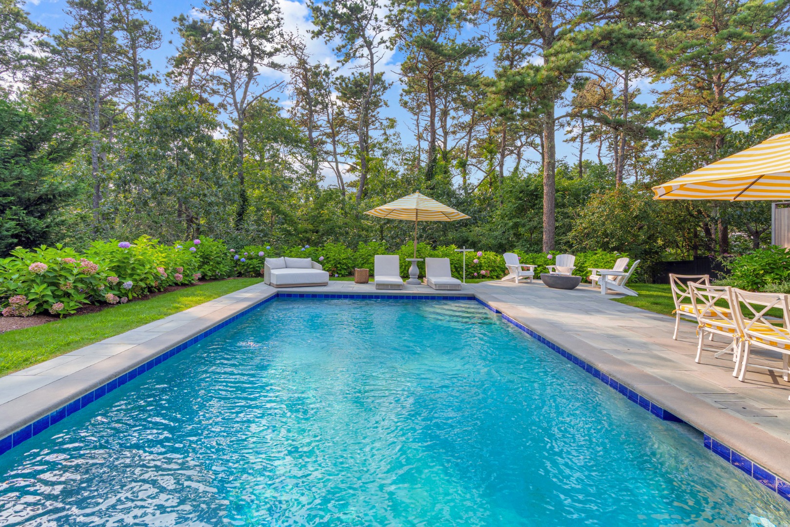 70 Marthas Road Edgartown, MA 02539 - Photo 47 of 54 a view of a patio with a table and chairs under an umbrella