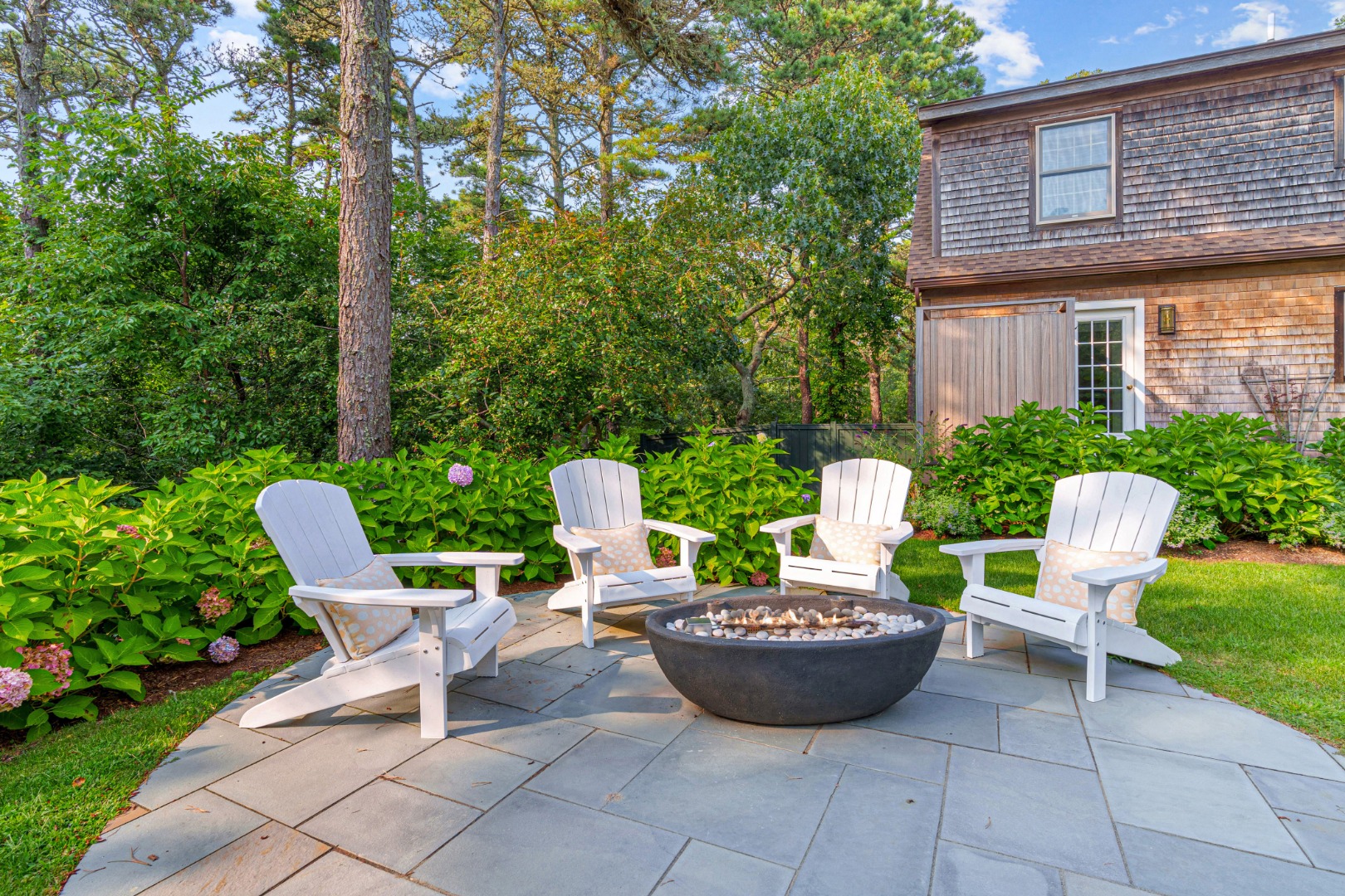 70 Marthas Road Edgartown, MA 02539 - Photo 52 of 54 a view of a chairs and table in backyard of the house