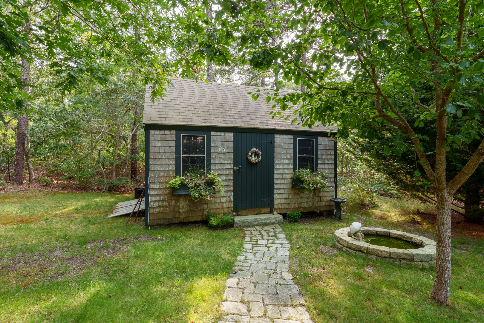 70 Marthas Road Edgartown, MA 02539 - Photo 54 of 54 a front view of a house with garden