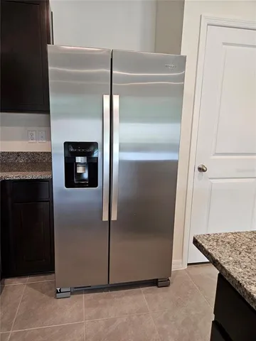a refrigerator freezer sitting inside of a kitchen